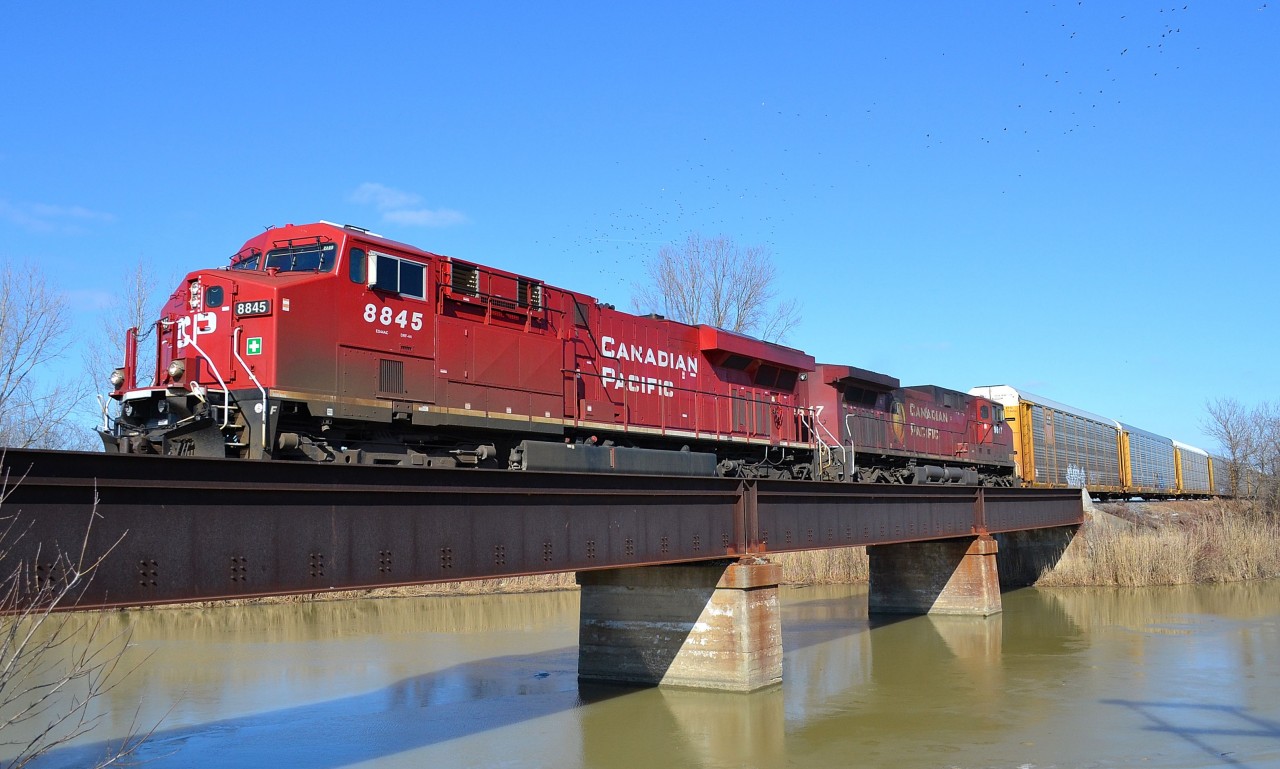 CP 141 led by a pair of GEs, crosses the canal bridge at Merlin Road as it heads westbound towards Windsor.