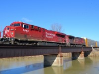 CP 141 led by a pair of GEs, crosses the canal bridge at Merlin Road as it heads westbound towards Windsor.