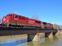 CP 141 led by a pair of GEs, crosses the canal bridge at Merlin Road as it heads westbound towards Windsor.
