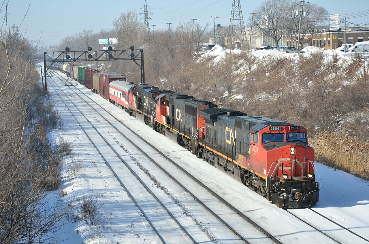CN 324 departs Montreal\'s Taschereau Yard for St. Albans, VT.  Behind the power is CN private car \"Sandford Fleming\".