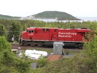 An eastbound heads through the West OS track at Marathon with the closed Marathon Pulp mill and Lake Superior behind