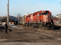 CP 248 at Galt passing the old station and a lady out walking her dog.