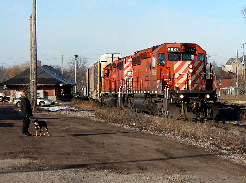 CP 248 at Galt passing the old station and a lady out walking her dog.