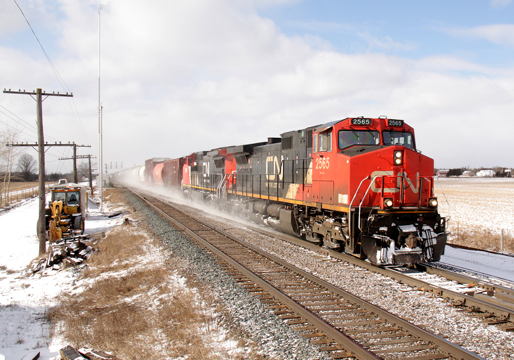 CN M30831 12 passes through Marysville with CN 2565 + CN 2196 at the helm... I guess when they painted the 2196 they forgot to add the numbers to the rear conductors side!