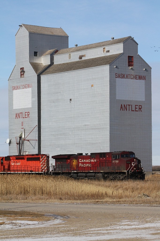 CP 9720 and 6036 head lite for Brandon as they roll on by the old Wheat Pool elevator at Antler Saskatchewan on the Arcola Subdivision.