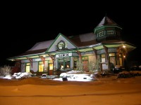 Former CNR Station in Glencoe, Ontario, fully light up, with a Caboose in the background.