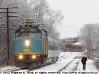 <b>Tresspassing: </b>Watching the train, walking on railway property, a man observes Train 85 with rebuild VIA 6437 pass through Guelph, Ontario.