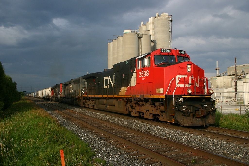 CN 321 gets underway after making a lift at St Marys Cement in Bowmanville under threatening skies