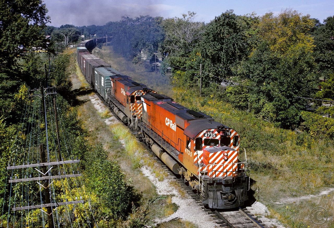 On a glorious late summer morning, the big guys CP 4735 and 4737, get under way leaving the CP\'s Windsor Yard with Montreal bound train 904.