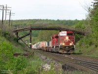 The classic Campbellville shot. CP 9678 and 8816 haul train #241 westbound under the classic wooden bridge that serves as a private crossing near Canyon Road.