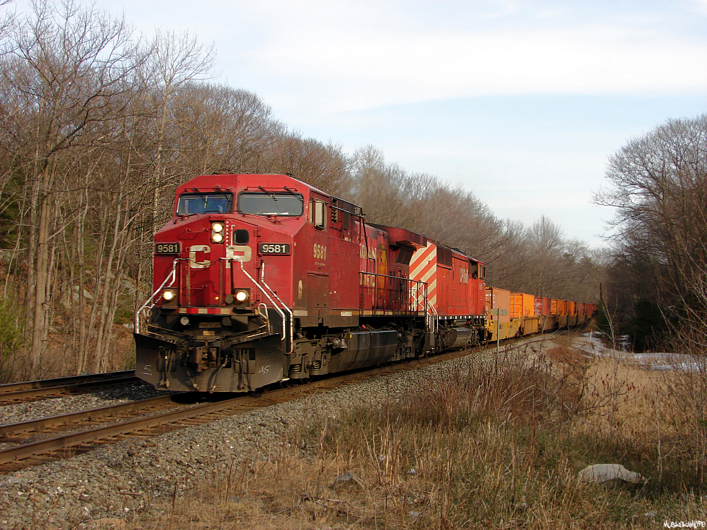 CP 9581 North with 223\'s freight heading into the setting sun at Bala, 9581/9014 have no problem keeping today\'s short 70 car train under control and at speed!