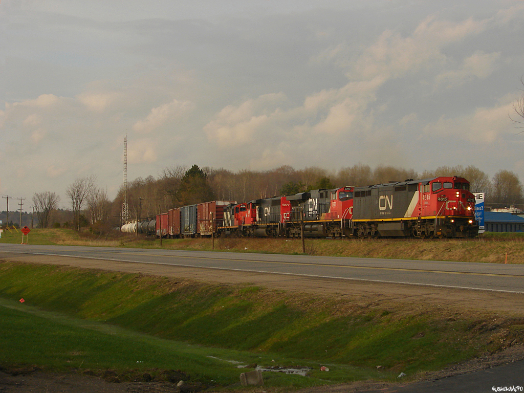 CN X45031 06 - BCOL 4615 South still pulling hard trying to get their heavy 86 car train out of \"The Bowl\", dialing up CB to request a light back into CTC a few miles ahed at Gravenhurst.