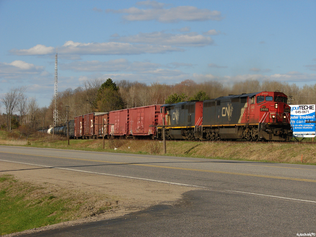 These aged GE\'s lug their 62 car train up the grade approaching South Falls with train A45031 07.