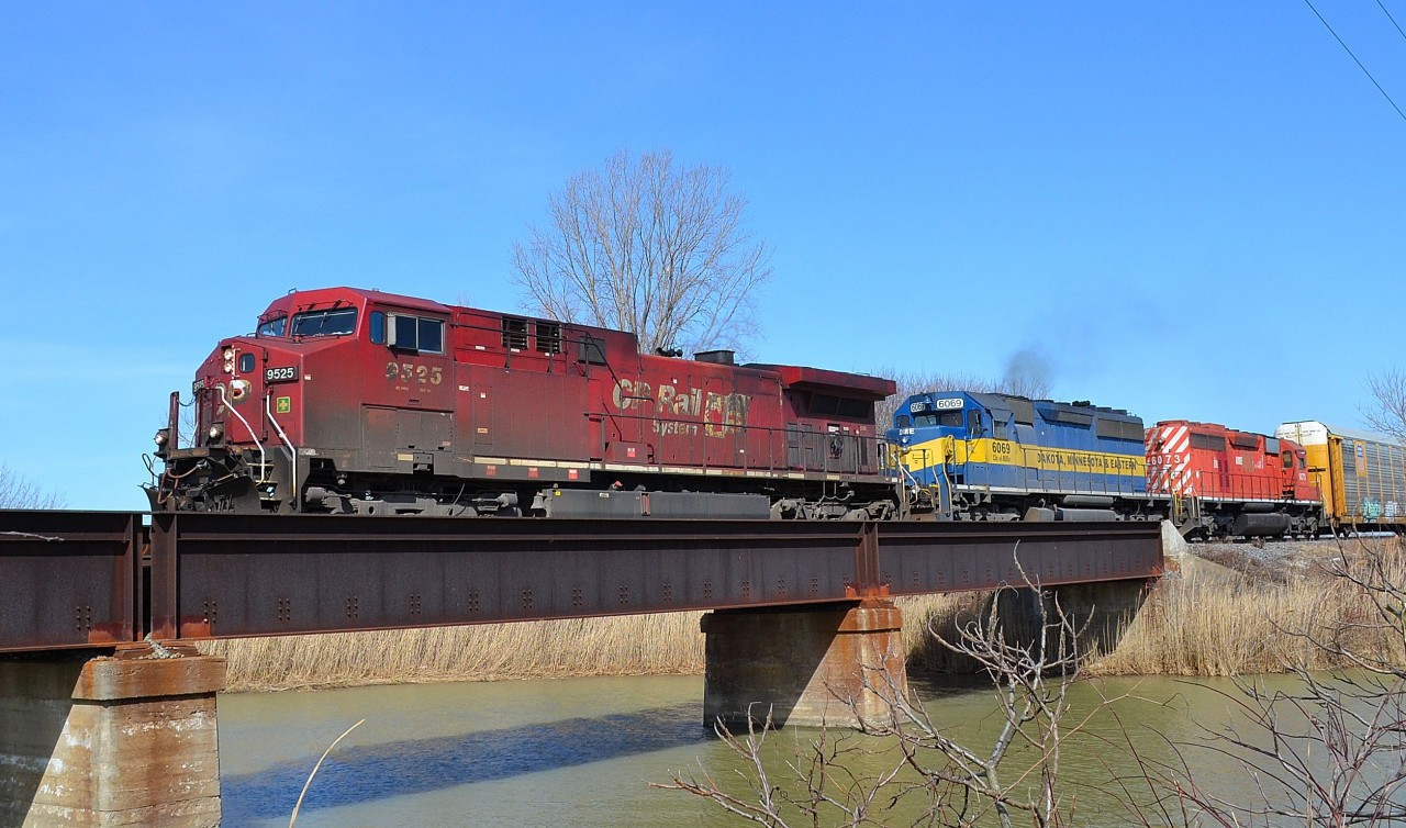 CP 641 led by a CP and a pair of DME heads westbound over the Merlin Road canal bridge.