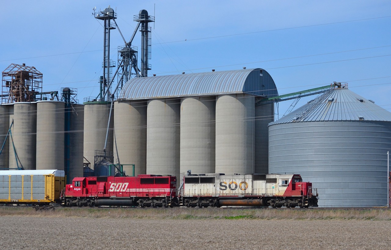 CP 240 led by SOOs 6036 & 6046 rolls eastbound past the grain elevator at Haycroft.