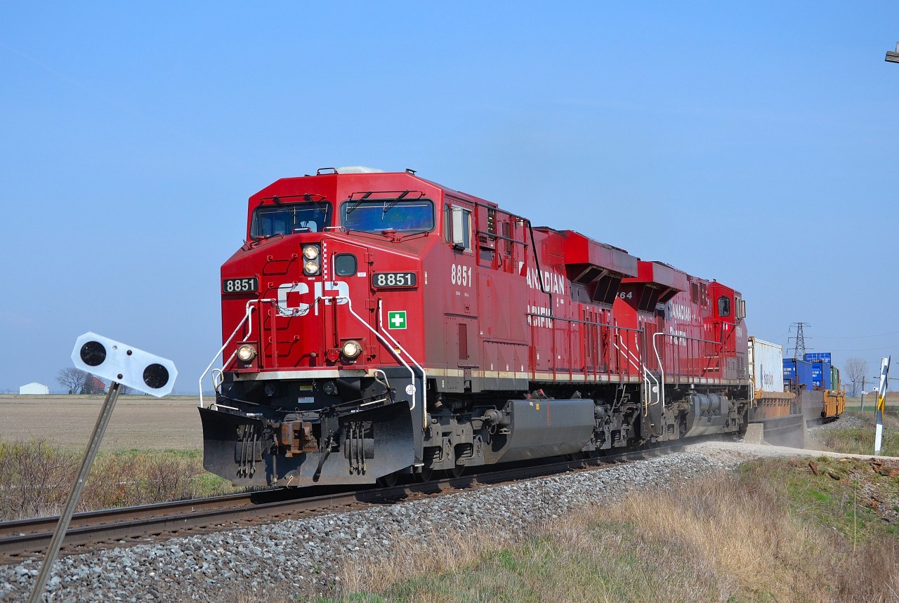 CP 141 led by a pair of ES44ACs, rounds the bend into Tilbury and heads westbound towards Windsor.