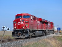 CP 141 led by a pair of ES44ACs, rounds the bend into Tilbury and heads westbound towards Windsor.