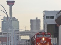 CP 8904 leads a manifest at Sunalta mp 1.5 on the Laggan Sub with the Calgary skyline in the background.