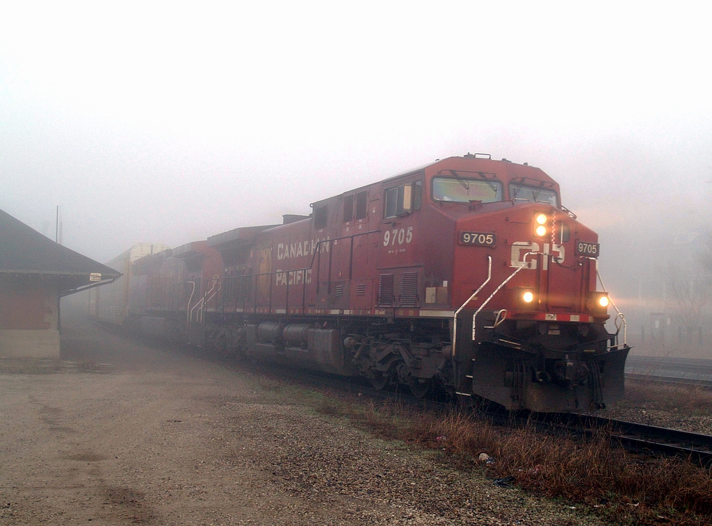 Emerging from the morning fog, CP 440 is passing by the Galt station @ 08:12 with CP 9705 - CP 9655 and 81 cars which included 42 loaded multi\'s on the head end.