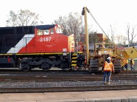 During the night CN 396 derailed in the Brantford Yard. Here the Hulcher unit has just hooked up to the front of 2197 and lifted it up to begin the process of re-railing the lead truck.