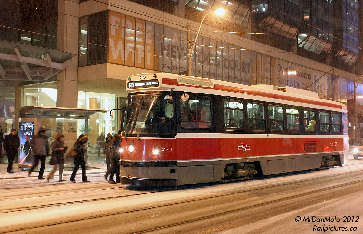 In one of the very few occurances snow actually fell in the Winter 2011-2012 season, we find TTC CLRV 4170 taking on passengers on the 505 Dundas route at Bay Street. While new subway car deliveries are progressing, not a single new streetcar/LRT has been delivered, and the fleet of 1970/1980\'s CLRV\\’s and ALRV\'s is for the most part very intact. As for the snow, it was all melted 2 days later.