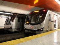 Pausing to switch crews, two Toronto Rocket consists with 5496 trailing northbound and a sister heading southbound wait together at the TTC's Queen Subway Station.