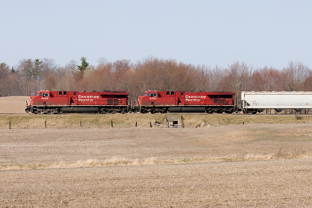 Westbound through the  thawing farm fields. (CP 8835, 8720)