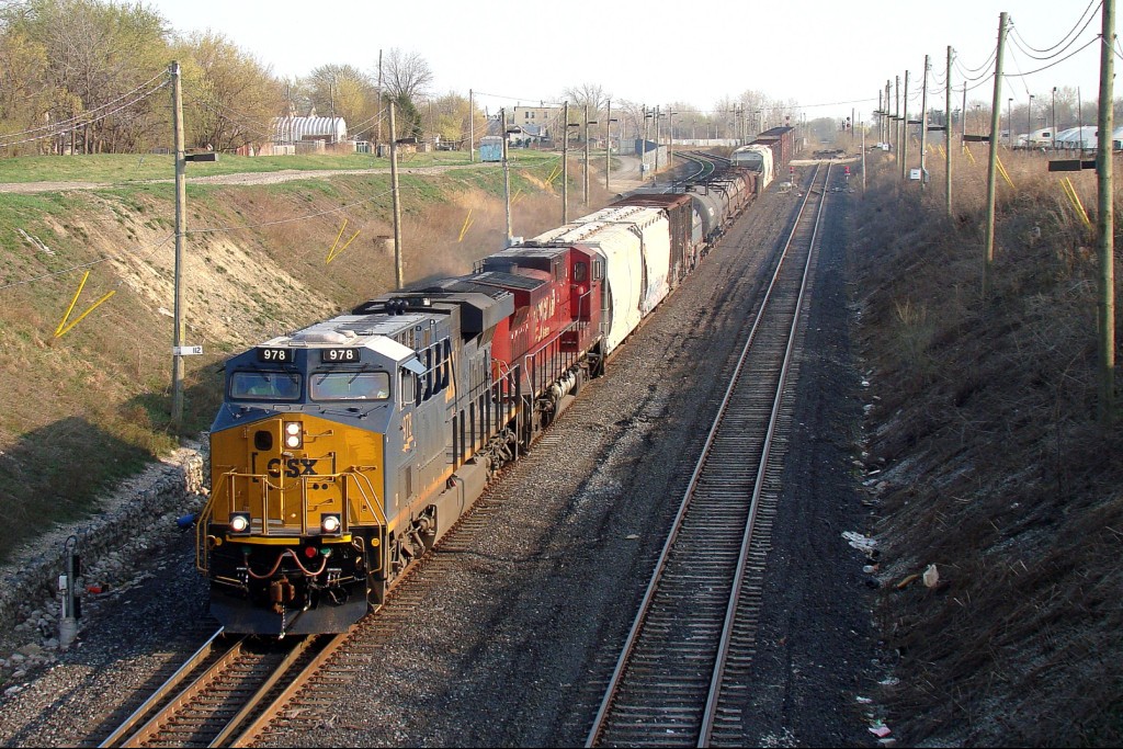 CSX D718 (CSX Rougemere to CN Van de Water) pulls 25 cars downgrade towards the tunnel behind CSX 978 and CP 9541.