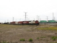 SOO 6033 and SOO 6048 cruise past the Milton GO Storage Yard with 18 cars