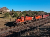 A pair of SD40-2's lead this Toronto to Sudbury freight through Palgrave on a sunny spring afternoon. 