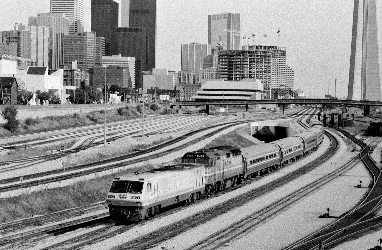 The changing eastward view from Bathurst Street: One of four images showing the changes through years: 1979, 1980\'s and 2011. The International with LRC 6903 and Amtrak 218 on a Sunday, 1987.  Kodak Tri X Pan b&w negative film. Photographer S. Danko