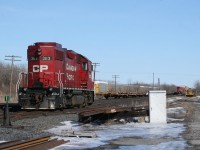 The Cobourg Turn and CP 235 sit in the siding at Brighton as CP 234's tailend rolls by on the main