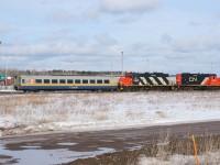 CN 7083 and 4102 move an unrebuilt VIA LRC car to IRSI for refurbishing, after meeting VIA 14 at the station.