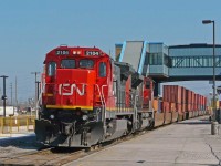 Awaiting the arrival of the outgoing crew, CN 149 sits just west of VIA Rail's new overhead bridge in Belleville.