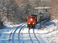 After one of the few snowstorms this winter, an eastbound passes the westward approach to Copetown West.