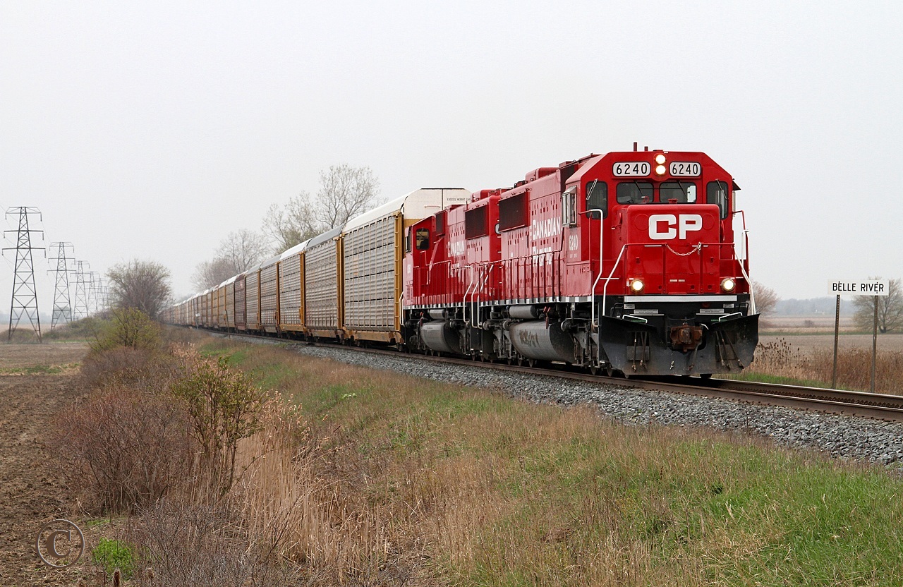 A couple of fresh ex SOO\'s, CP 6240 and 6260 lead train 242 eastward at the Belle River mile board.