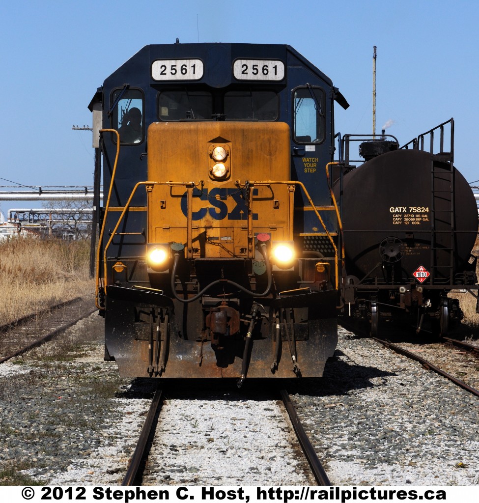 CSX\'s CN Transfer with CSXT 2561 and 2697 is back on home rails as they back their train of 50 cars into the Sarnia Subdivision yard.Notice the Hogger is seen giving the peace sign to the photographer.