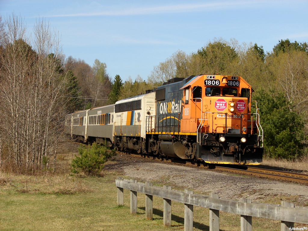 CN P69831 18 – ONT 1806 South pulls into Bracebridge for a quick station stop, despite Northern/Central Ontario\'s best efforts, scene’s like this may soon be history. Recently, crews all over Ontario Northland’s system have been applying these ”STOP the sale of ONTC” signs on many of ONT’s locomotives showing their support tor the protest.