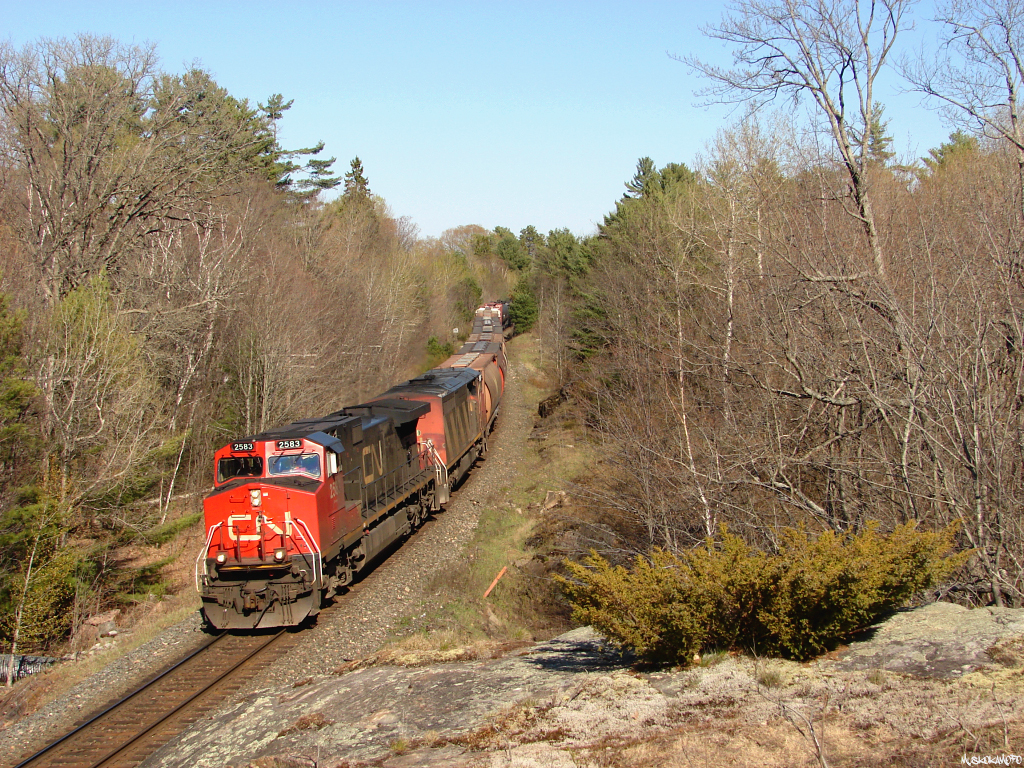 CN X30131 29 - CN 2583 North rounding the s-curve just North of Sparrow Lake with 94 cars heading for Symington at speed.