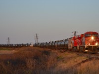 CP 643 led by a pair of Gevos, heads westbound as it rounds the bend in Tilbury on its way towards Windsor into a setting sun.