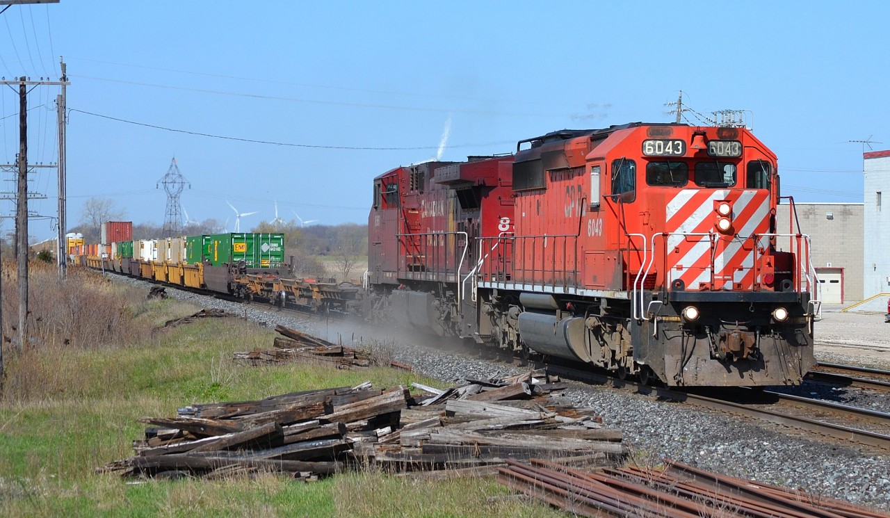 Getting kind of rare these days, an SD40-2 led CP 244 kicks up dust as it charges thru Tilbury headed eastbound.