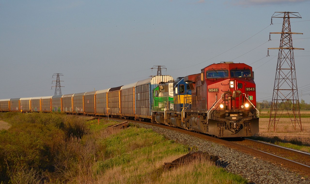 CP 147 led by CP 9543 along with an ICE and CITX trailing, rounds the curve heading westbound thru Tilbury into a setting sun on its way towards Windsor.
