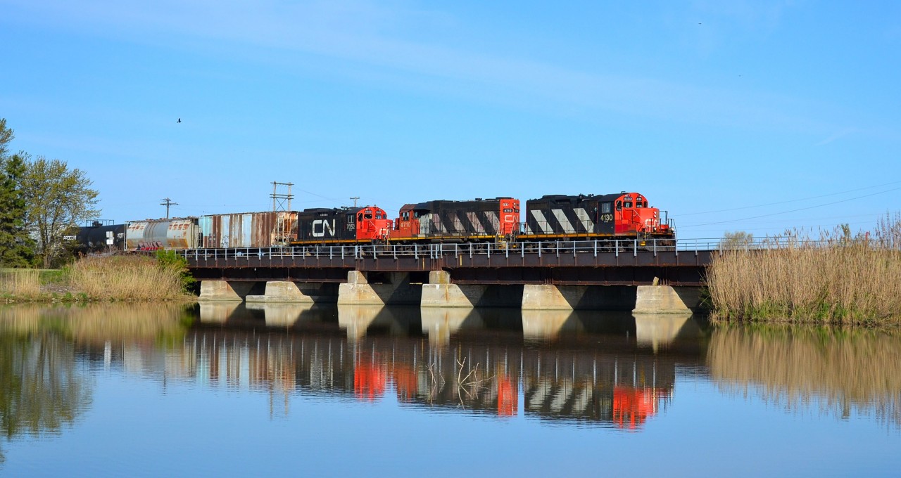 CN 438 led by a GP9RM, a GP38-2 & another GP9RM, heads eastbound over the bridge at Jeannettes Creek on its daily trip to London from Windsor.