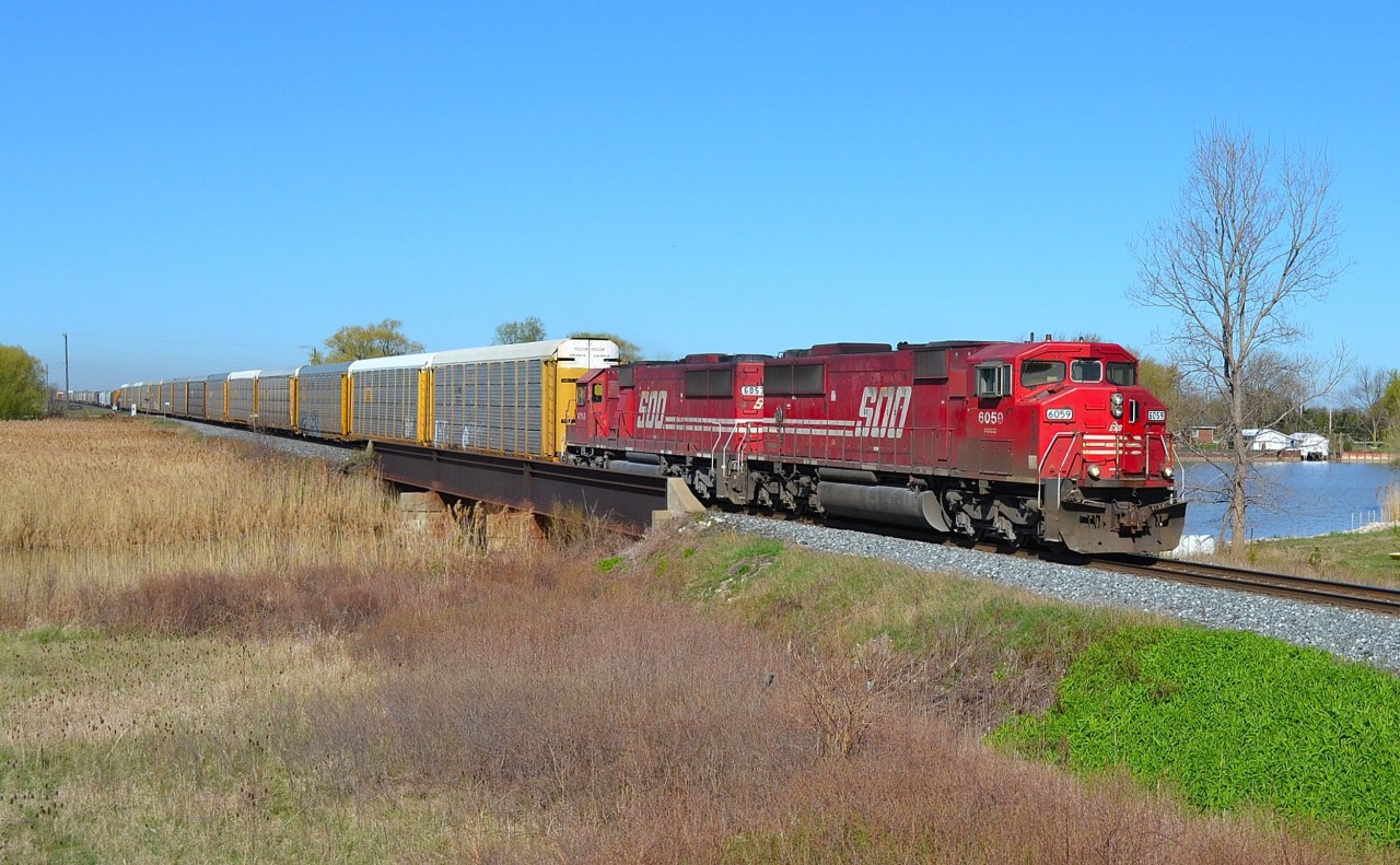 CP 240 led by SOOs 6059 and 6053 pass over the Ruscom River bridge as it heads eastbound at St Joachim.