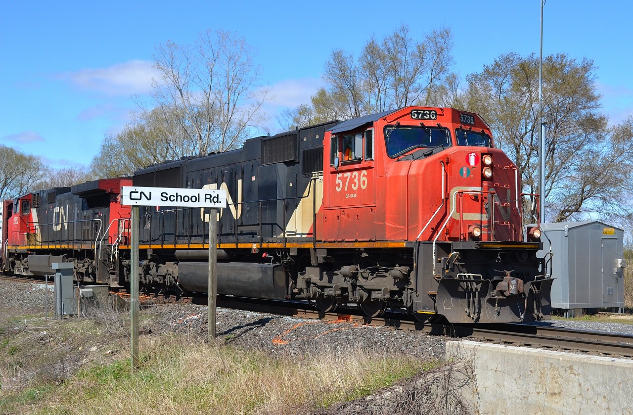 CN 509 led by SD75i # 5736 pulls out of the siding at CN School Road after letting a westbound train pass by