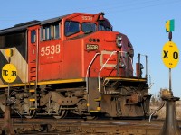CN SD60F 5538 (and sister CN 5554 out of the frame) sits on the "Northern Woods Lead" on a beautiful April evening, framed between the TC38 and the crossover switches at the west end of the yard at Thunder Bay North.
