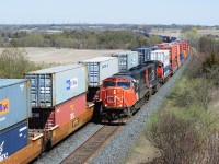 The ContaiNer-way is at capacity 13:51 April 18, 2012 CN Kingston Sub. mile 280.6 . CN #149 is powered by sixteen year old SD75I's #5687 - 5634 while the eastbound with 8957 - 2535 approaches the Newtonville crossover. Image by S.Danko.