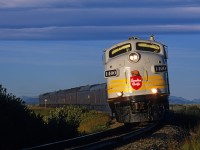 The Royal Canadian Pacific excursion train curves into the morning sun at milepost 54 on the Crowsnest Pass route, west of Brockett, Alberta, on September 22, 2002.