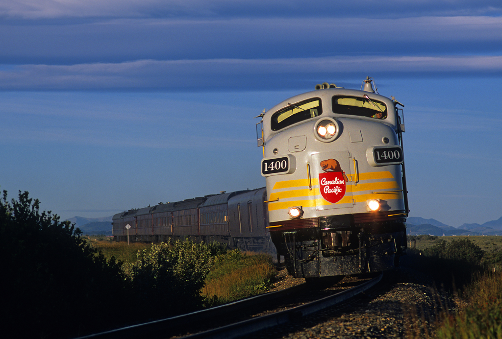 The Royal Canadian Pacific excursion train curves into the morning sun at milepost 54 on the Crowsnest Pass route, west of Brockett, Alberta, on September 22, 2002.