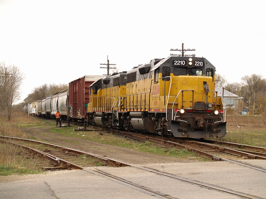 GEXR\'s train 582 has just arrived at Guelph with LLPX 2210 - LLPX 2236 and 16 cars. Once they clear the switch were the crew member is located they will back in the clear and then turn north and set off some cars inthe yard.